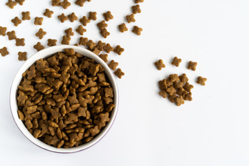 a bowl of dog food on a white surface