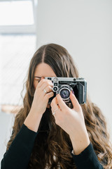 long-haired brunette girl photographed on an old camera
