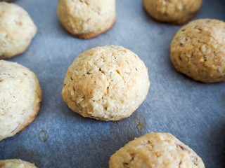Round gluten-free cookies made of almonds, eggs , butter , sugar, corn and rice flour on parchment paper side view 