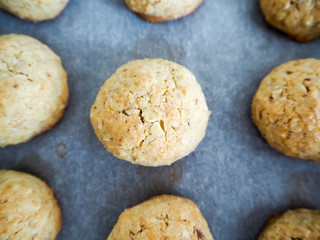 Round gluten-free cookies made from almonds, eggs , butter , sugar, corn and rice flour on parchment paper . Dietary c