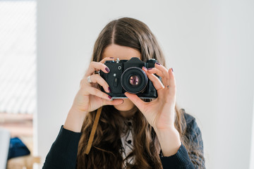 long-haired brunette girl photographed on an old camera