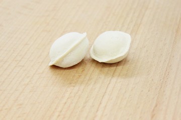 Delicious fresh frozen dumplings located on the cutting board