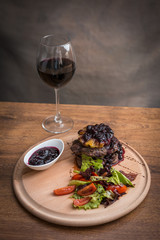 Steak with grilled vegetables and seasoning on serving plate