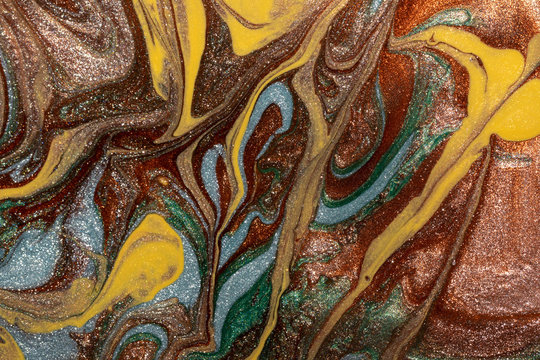 Abstract background of mixed shades of nail polish with a shiny