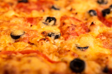 baked pizza background with cheese, tomatoes and olives