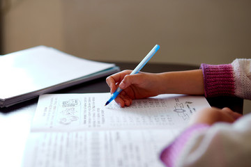 Unrecognizable girl doing homework, writing education concept, Coronavirus