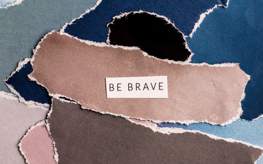 cutout, colorful artistic collage with the words "be brave"
