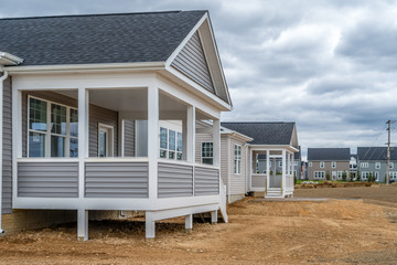 Newly built American single family home in a 55+adult residential community with a covered porch...