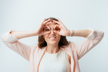 girl shows hands binoculars