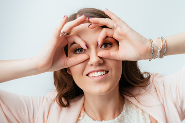 Fototapeta premium girl shows hands binoculars