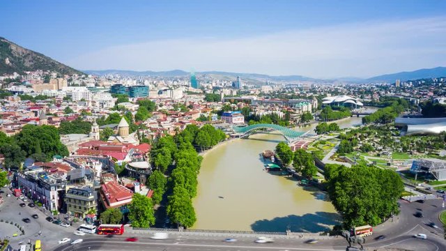 Hyperlapse flight over of the old town on Sololaki hill, crowned with Narikala fortress, the Kura river and cars traffic in Tbilisi, Georgia.