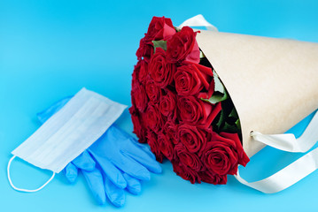 contactless delivery - face mask medical glove and bouquet of red roses, concept of quarantine and...