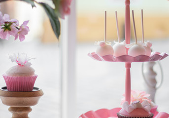 Beautiful rose cupcakes near the window. 
