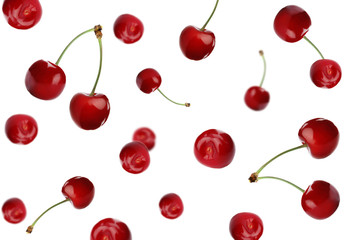 Set of falling ripe cherries on white background