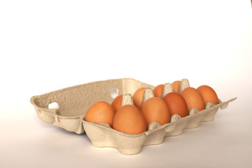 Container with a dozen chicken eggs. Chicken eggs in an open container.