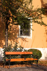Obraz premium Empty bench against old yellow house in Budapest on Buda side. Buda hills is huge area in West part of Budapest