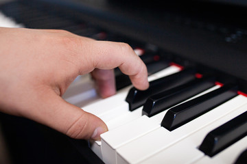 Fototapeta na wymiar Close up of man's hands playing on keyboard