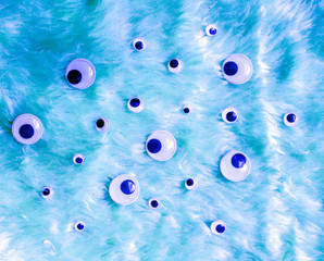 Funny Wiggle Google Eyes on Blue Fur Fabric Silly Background
