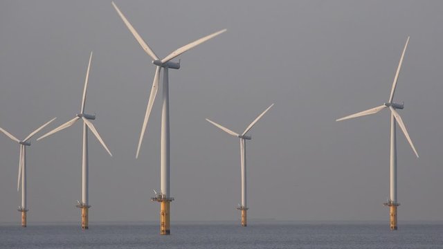 Offshore wind turbine farm off teesside North east England UK 4K