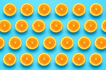 Fruit pattern of orange slices on vibrant blue background