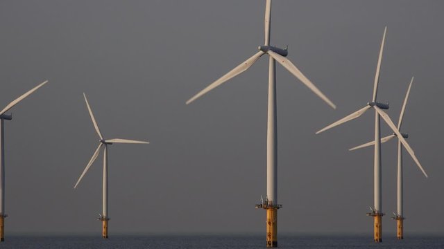 Offshore wind turbine farm off teesside North east England UK 4K