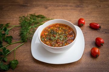 Soup of solanka on the wooden table..