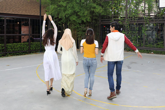 Group Young Asian Chinese Malay Man Woman Wearing Headscarf Outdoor Walk Talk Discus Friend Student Colleague Happy Exited Form Back