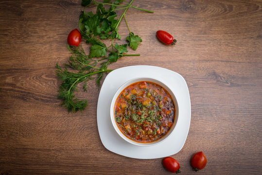 Soup of solanka on the wooden table..