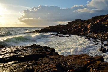 The beautiful rocky coast is taken waves on sunset