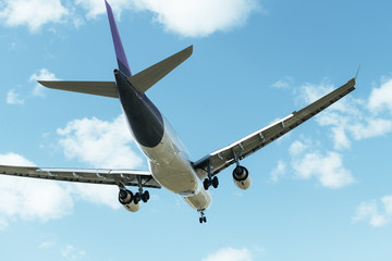 commercial aircraft flying seen from behind