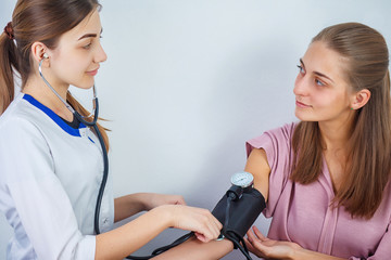 Close Up Of A Doctor Checking Blood Pressure Of A Patient. Healthcare, healthy lifestyle and medical service concept.