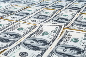One hundred dollars. US dollars background. Closeup of a lot of banknotes hundred dollar bills. American currency.