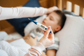 Thermometer close- up during the child's illness . The virus and the epidemic