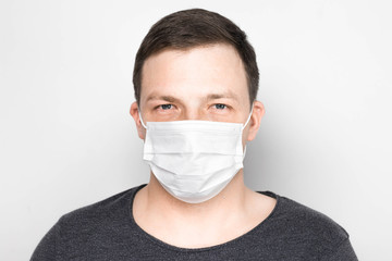 Man with medical mask on face. Protection against viruses and infections. Stay home, corona virus.