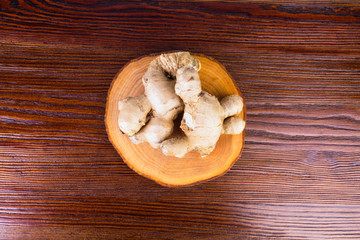 Fresh ginger root on wooden table