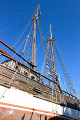 Obraz premium old wooden yacht with blue sky on the background