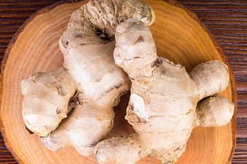 Fresh ginger root on wooden table