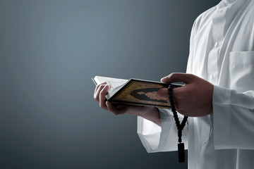 Religious muslim man reading holy quran - 336115230