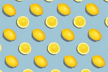 Colorful fruit pattern of fresh lemon slices on colored background. Lemon slices top view. With sharpen shadows
