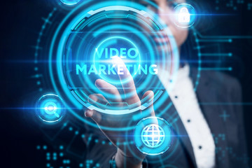 Business, Technology, Internet and network concept. Young businessman working on a virtual screen of the future and sees the inscription: Video marketing