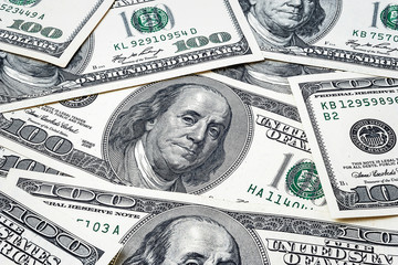 One hundred dollars. US dollars background. Closeup many banknotes hundred dollar bills. American currency.
