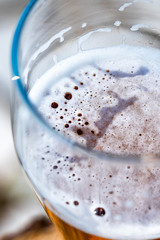 Light beer in a glass wine glass on a picnic on the nature