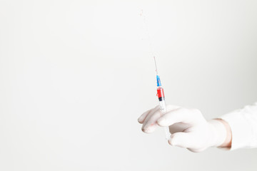 Syringe for medical injection in doctor's hand. Medicine plastic vaccination equipment with needle. 