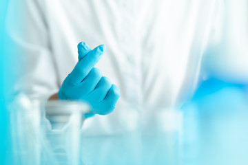 hands gesture of doctor wearing blue gloves, mini heart shape sign for love