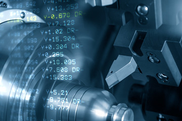 The abstract scene of CNC lathe machine rough cutting the metal shaft parts and the NC data background. The hi-technology metal working processing by CNC turning machine .