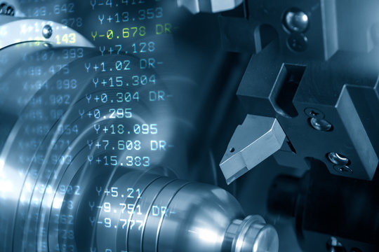 The abstract scene of CNC lathe machine rough cutting the metal shaft parts and the NC data background. The hi-technology metal working processing by CNC turning machine .