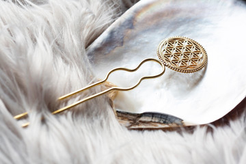 Brass metal yellow golden hair pin detail on natural rocky background