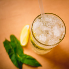 a glass of refreshing mojito drink with green mint and lime