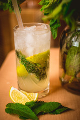 a glass of refreshing mojito drink with green mint and lime