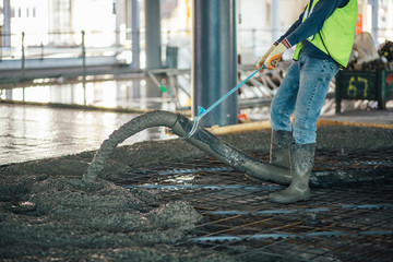 Construction worker pouring concrete